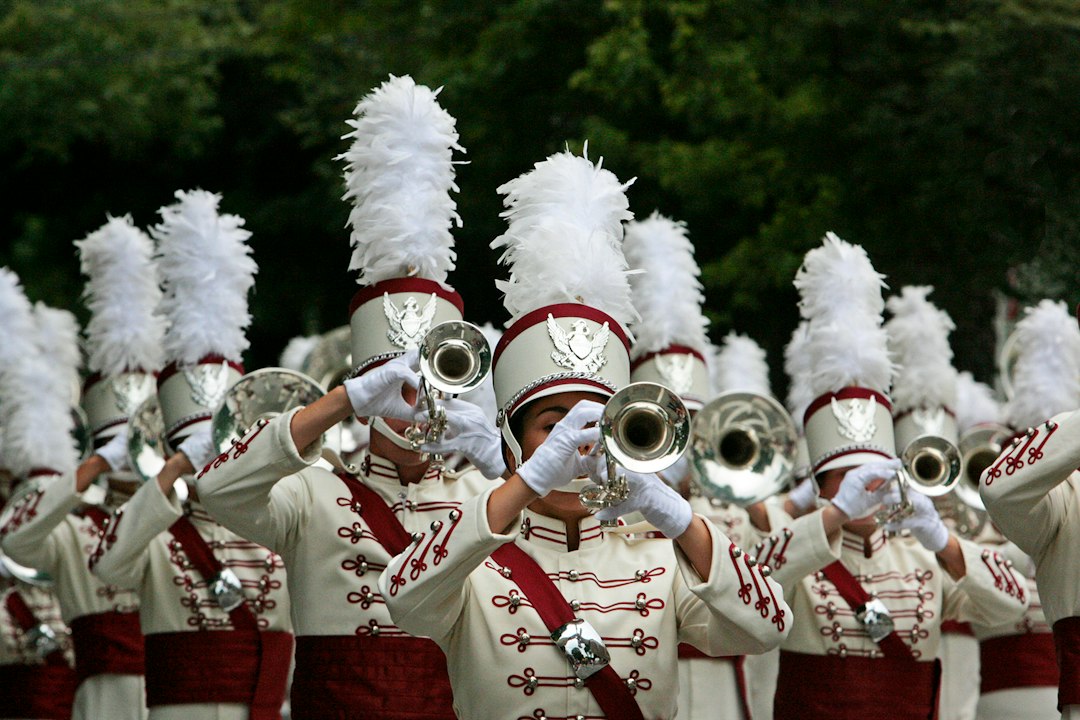 Marching band in red and white uniforms performing