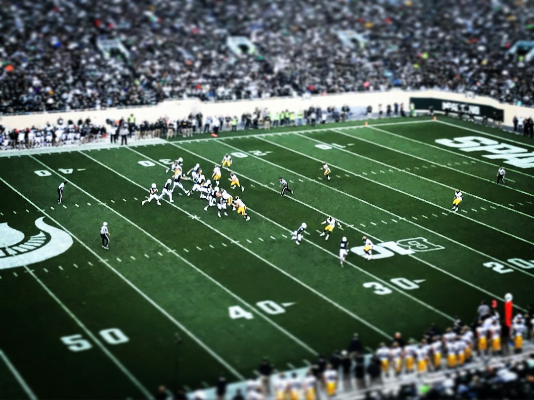 Quarterback throwing a pass during a night football game